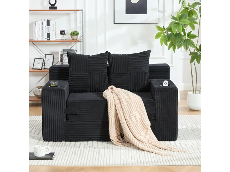 Canapé convertible 2 places avec deux coussins, porte-gobelet et poches latérales en velours côtelé noir - Conforama E