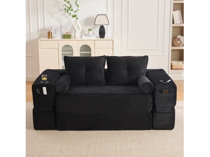  Canapé convertible 2 places avec poches latérales, porte-gobelet et coussins à mémoire de forme en velours côtelé noir  - Conforama D