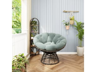Fauteuil papasan en rotin marron pivotant 360° avec coussin vert clair côtelé