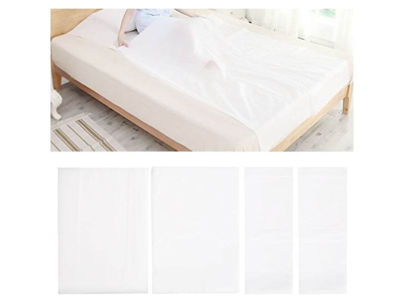 Lot de 4 housses de couette jetables sous vide whikon en tissu non tissé, comprenant draps, taies d'oreiller et sacs de rangement. Fournitures hôtelières. - Conforama A