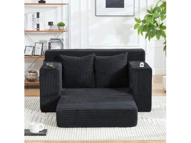 Canapé convertible 2 places avec deux coussins, porte-gobelet et poches latérales en velours côtelé noir  - Conforama D