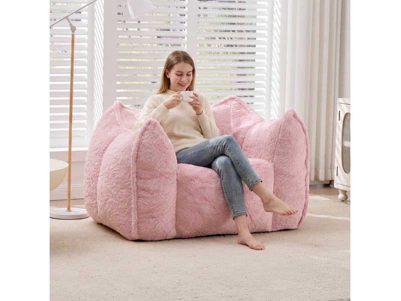  Fauteuil pouf avec dossier enveloppant et coussin, rembourrage en mousse, en fausse fourrure rose  - Conforama D