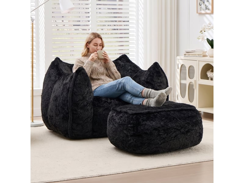 Pouf géant noir en fausse fourrure avec coussin et repose-pieds - Conforama B
